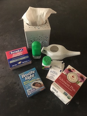 Collection of items for Austin's allergy season, including Kleenex, neti pot, and various over the counter medications